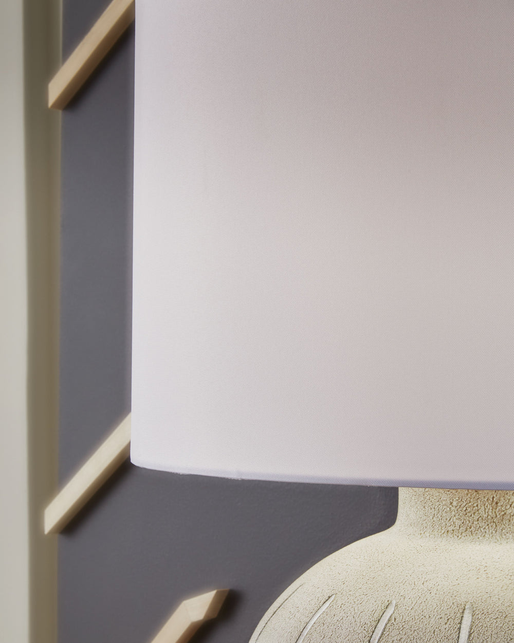 This is one casually cool table lamp. Its textured, neutral-toned base exudes a relaxed, inviting vibe that fits seamlessly into a variety of decors. Ideal for adding that cozy touch, this lamp lightens the mood and brightens your living space, bedroom or