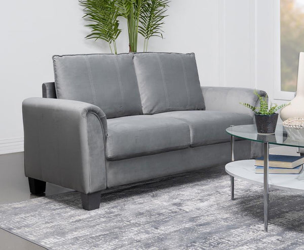  it boasts soft gray fabric with a velvety texture that encourages a cozy but sophisticated presence in your liv