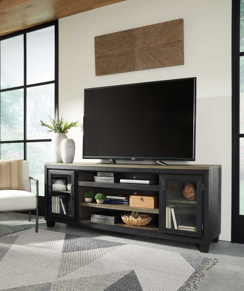 This TV stand with fireplace option is rustic, casual contemporary style simply done right. Its two-tone color scheme features a rich brushed black finish accented with a dusty grayish brown wood tone. With two glass-front cabinets (each with an adjustabl