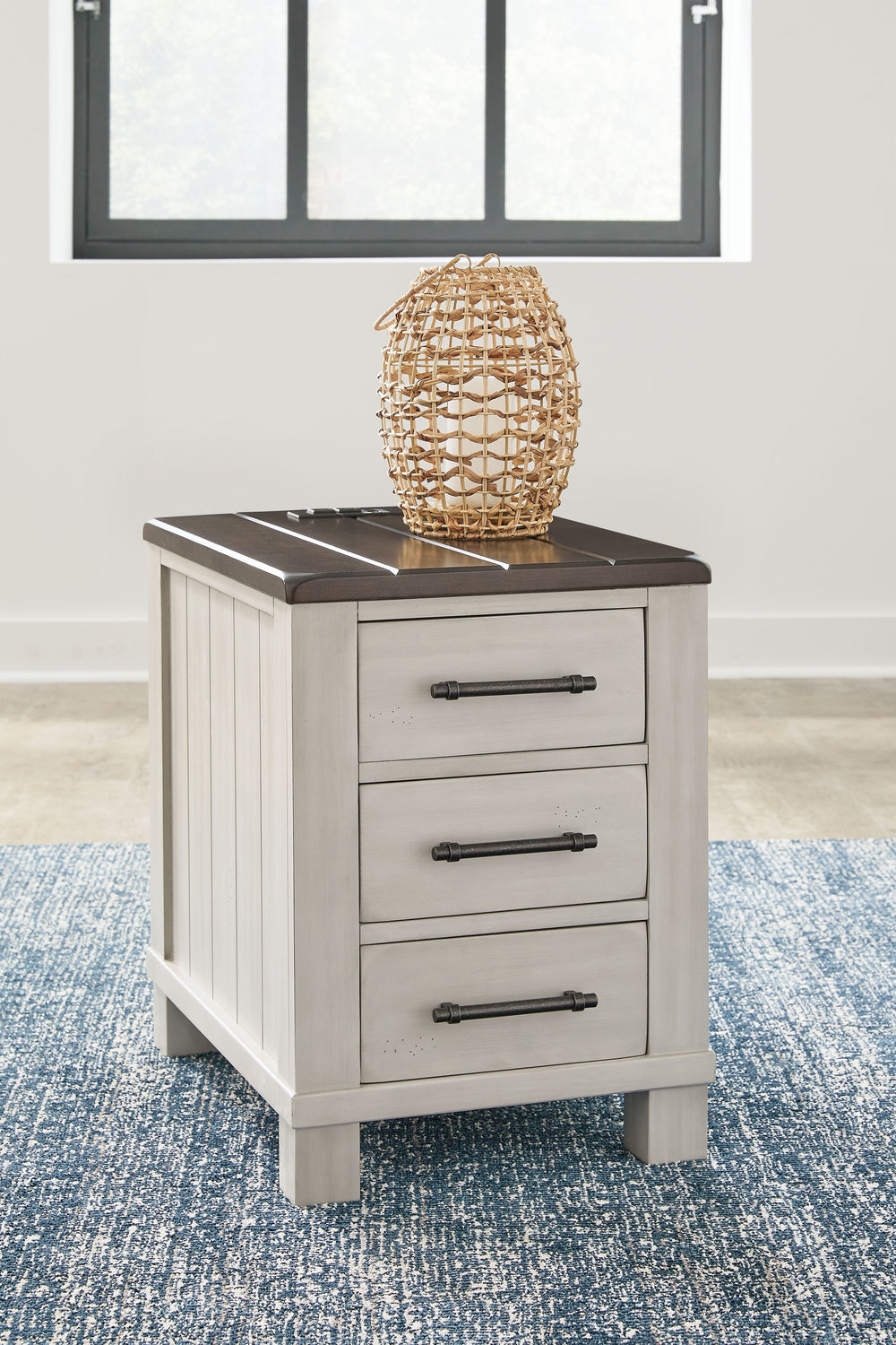 Make a farmhouse-inspired statement with this end table. Beautifully crafted to stand the test of time, the planked effect and clean two-tone finish lend a relaxing vintage feel. Spacious storage drawers with metal pulls double up on form and function. Pl