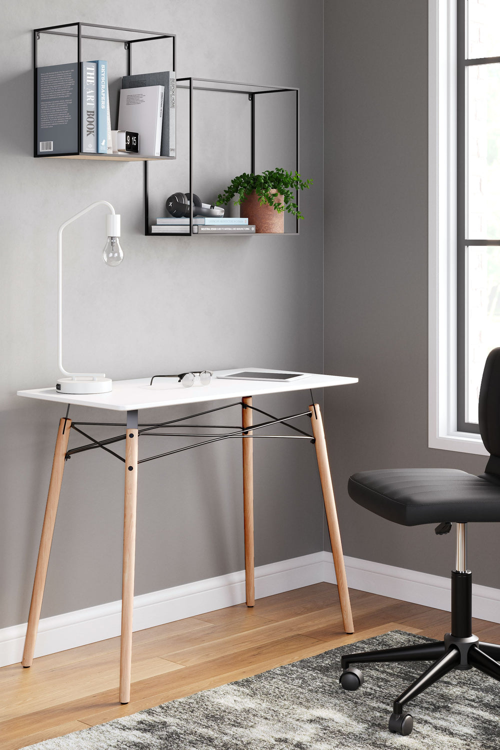 A contemporary take on a classic look, this home office desk adds a touch of artistic flair to your at-home work experience. It-'s designed with small space living in mind, and is perfect for small apartments and dorms. With its painted white top, black m