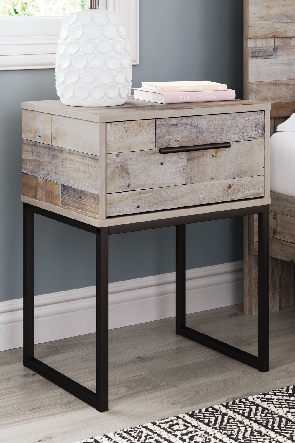 Part beach chic, part urban hip, this nightstand is everything you dreamed of, at a comfortably cool price. The butcher block whitewash finish over replicated pine grain lends a richly relaxed aesthetic that suits your sensibility. A dark pewter-tone draw