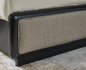 this softly shaped queen upholstered panel bed makes a lasting impression in a simply stunning way. Its magnificent curved silhouette is enhanced by a rich layered black finish on the textured wood grain surface. The channeled