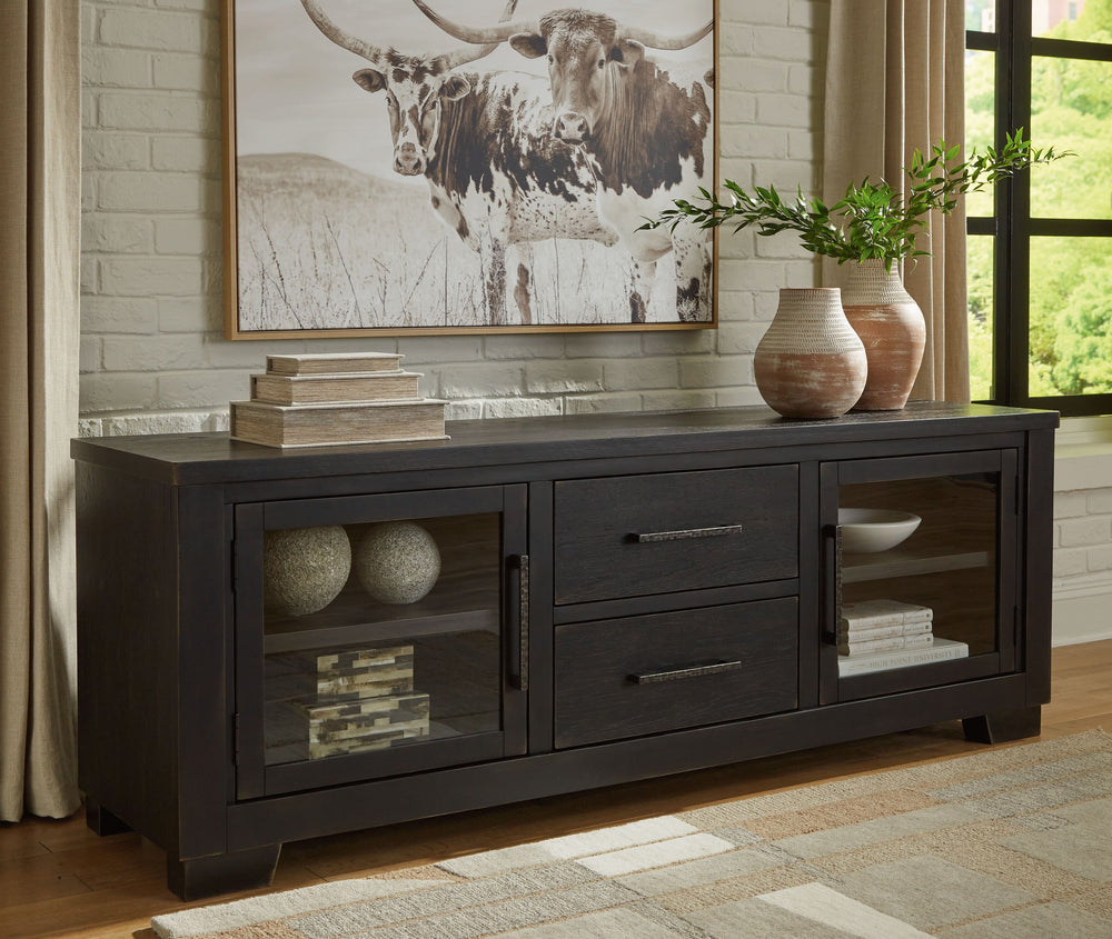 This TV stand brings a rustic vibe to urban contemporary design. Itâ€™s a modern approach to natural beauty, with the worn black finish giving your living room a gently aged charm. Console and media storage is made easy with cabinets and drawers. And the 