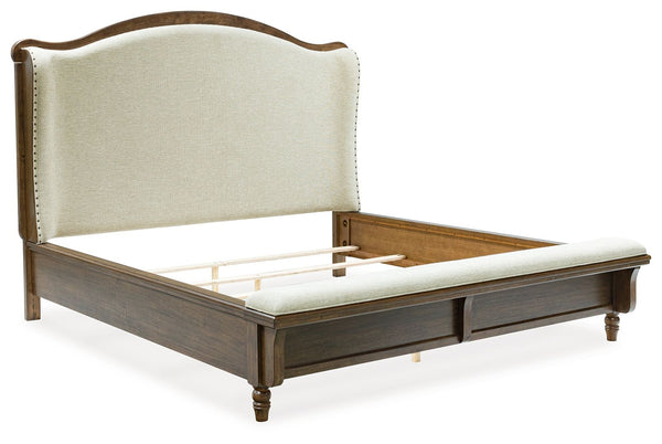 Traditional style doesnâ€™t have to be stuffy. It can feel warm, inviting and beautifully in the moment. Case in point: this queen upholstered panel bed. The alluring piece features a distinctive headboard with a shelter wing design. Its cushioned bench f