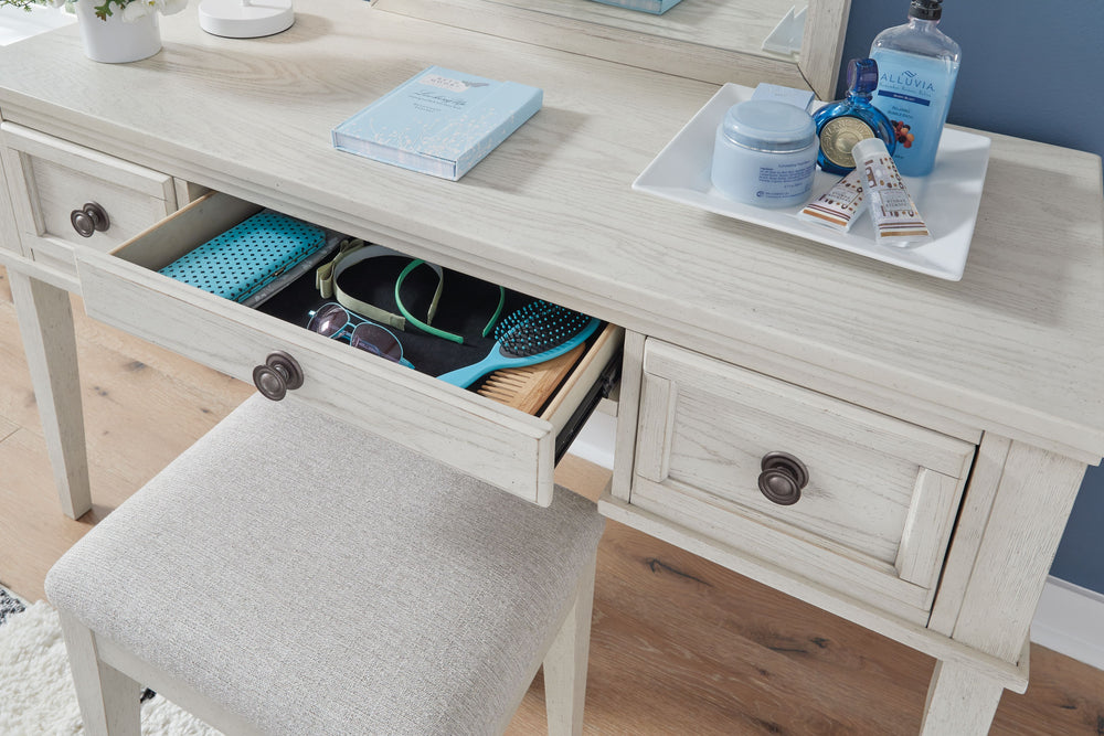 Elegant, timeless furnishings take your bedroom to the next level. Nothing does that better than this vanity and stool set. The antiqued white finish with a wonderful grain texture radiates sophistication, while dark bronze-tone knobs add an ornate touch.