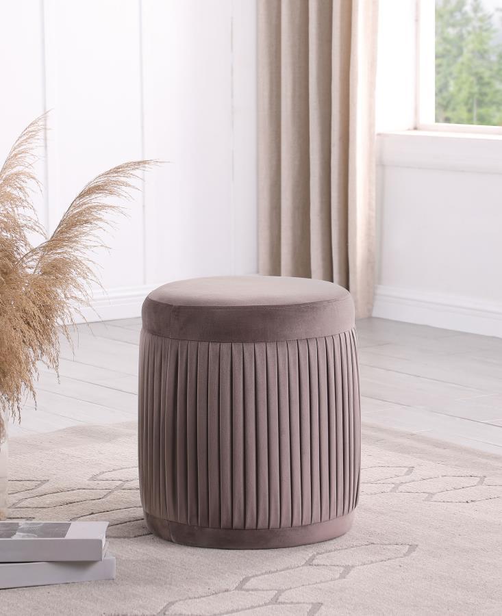 Add a hint of comfort and color to your living room with a modern drum ottoman. Its petite size is perfect for an accent chair, offering flexibility to serve as footrest or seat. It features mauve upholstery with a deep, muted tone that complements in a w