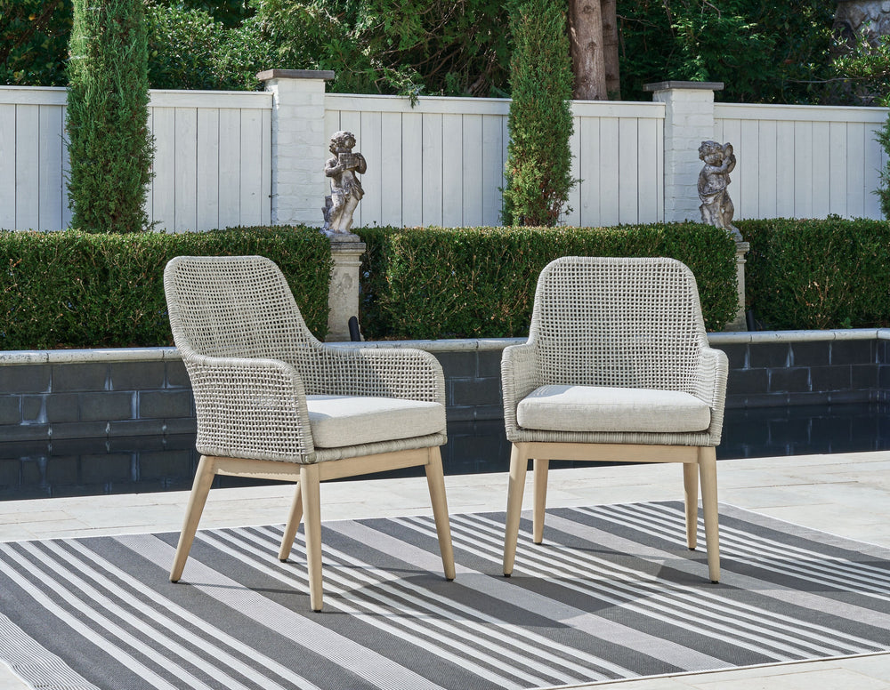 This dining arm chair invites your casual contemporary style outdoors. With its resin wicker in a chic neutral hue, it expertly marries refined design with durability. Breezy summer mornings and cold winter nights are made all the more comfortable with hi