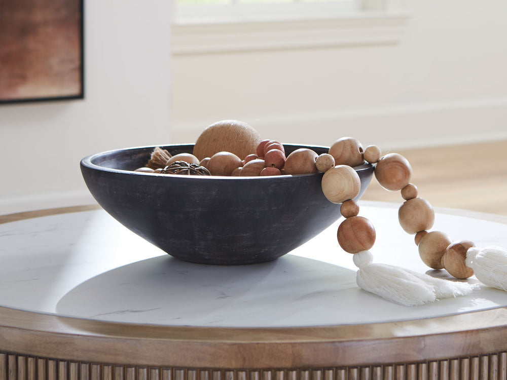 Celebrate the artisanal character of ceramics with this bowl. Its distressed black finish has a time-worn, weathered appeal, offering the look of the past with a modern feel. The bowl-'s neutral tone makes it a go-to for all seasons, allowing you to stage