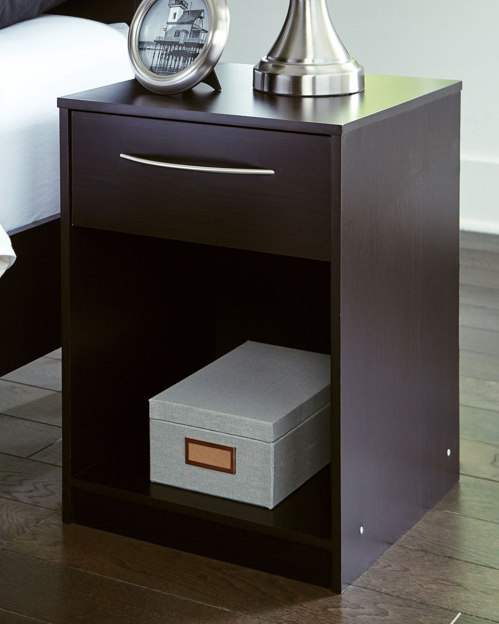 Practical and attractive, this nightstand blends seamlessly with modern decor and makes a smart addition to a bedroom. The smooth-gliding drawer on metal ball bearings is ideal for bedside essentials. An open cubby provides a nice place for a storage bask