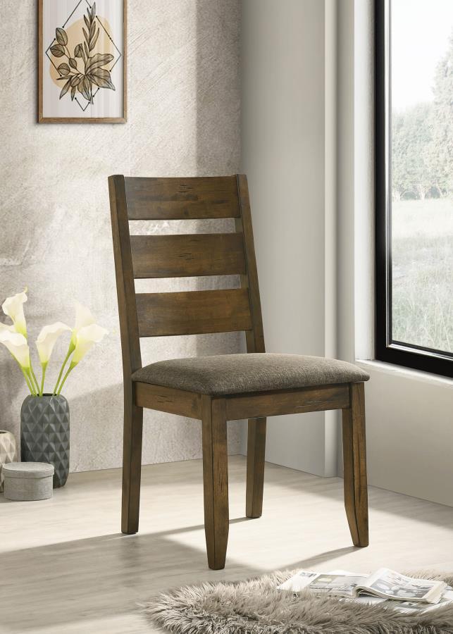 With classic glamour and contemporary comfort, this dining chair is an attractive upgrade to an eat-in kitchen or dining room. Crafted from hardwood with knots and organic wood grain, its modern silhouette has a delightful twist of rustic charm. Its back 