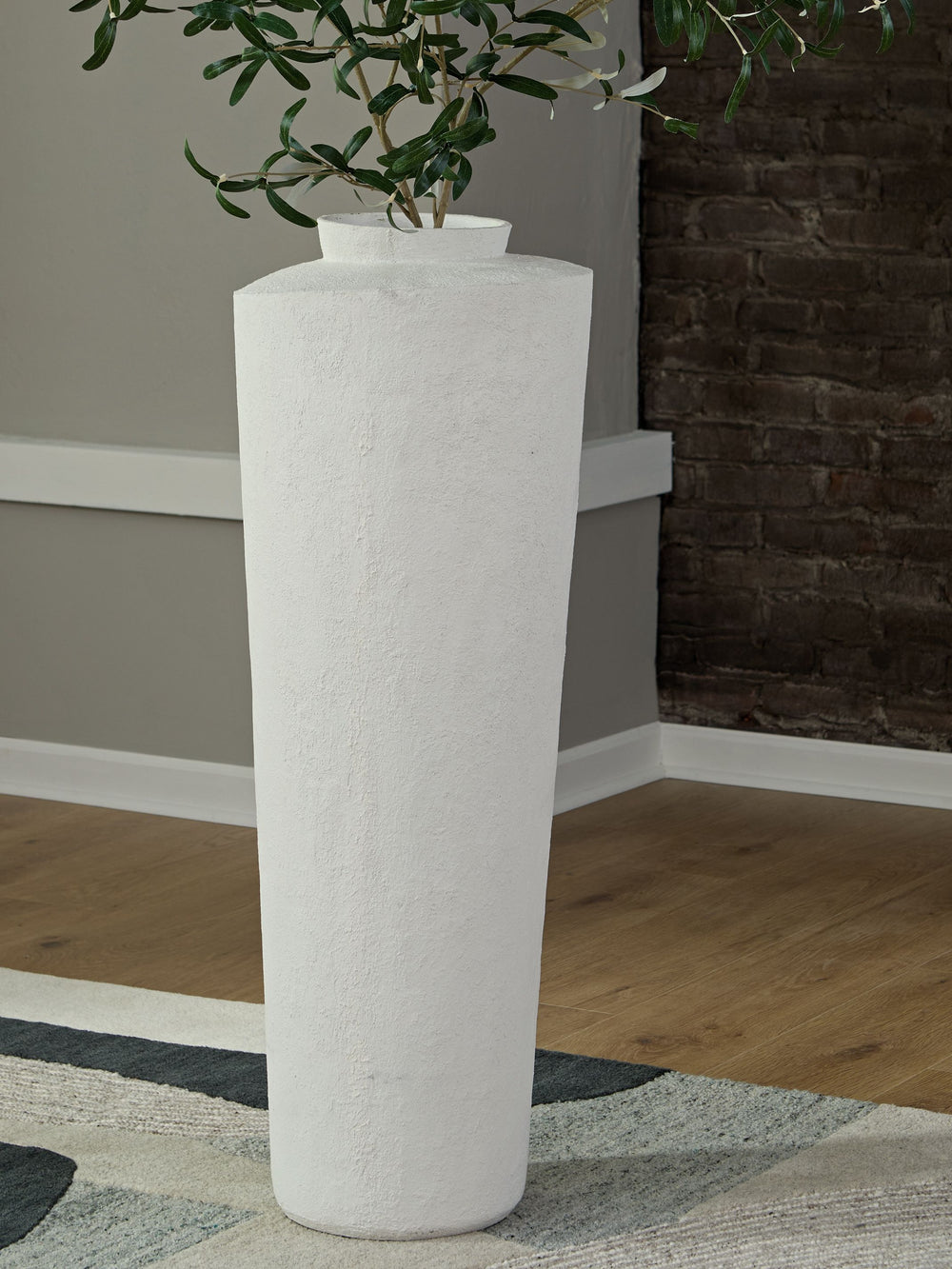 Simply chic. With its textured pattern and asymmetrical top, this cream-colored floor vase is a subtly stylish addition to your decor. Refresh the look by switching out your favorite faux floral arrangements from season to season.<br/><br/><b>Product Feat