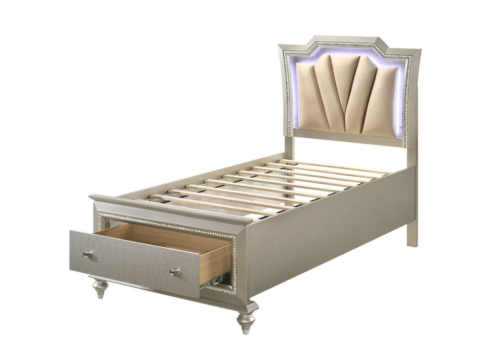 The Kaitlyn bed provides a commanding presence in any master bedroom. This contemporary storage bed in champagne finish features a diagonal channeled tufted padded headboard and a low-profile footboard with storage drawers. Expertly crafted with a glam lo