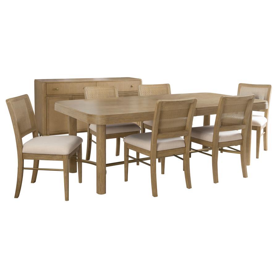 This dining set blends modern craftsmanship with natural textures for a refined yet inviting feel. The dining table features a trestle base with an antique brass-finished metal stretcher bar, adding stability and contrast. Rounded corners soften the recta