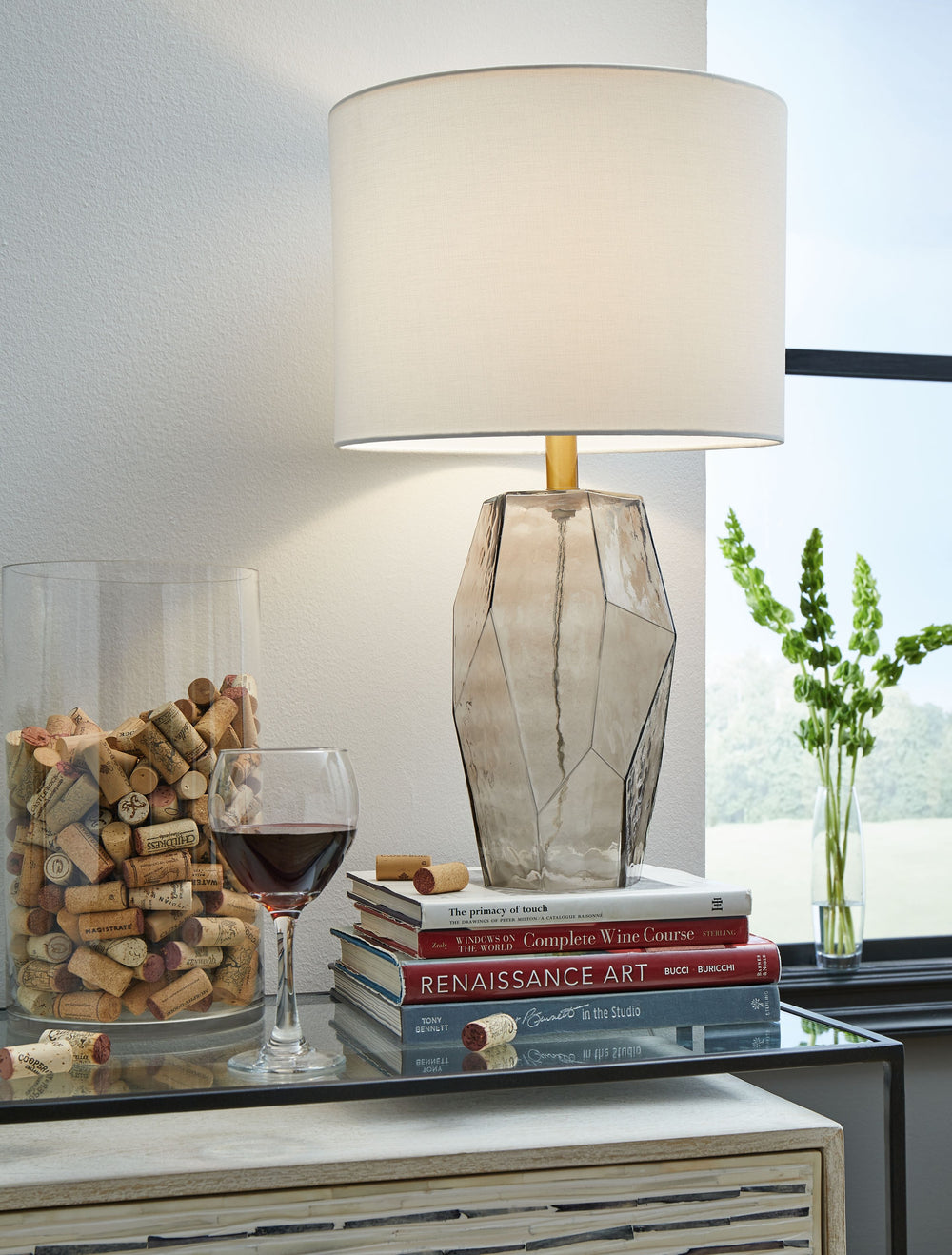 An elegant profile makes a simple yet stunning statement when viewed from any angle. This translucent glass table lamp, with its hexagon-shaped base, adds fluidity with a cool textured effect, providing an intriguing look for modern or transitional spaces