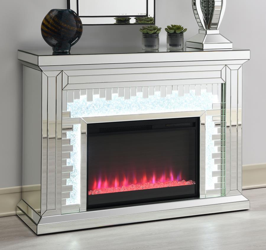 Crushed crystal accents glimmer and sparkle in this unforgettably stunning modern fireplace. Wrapped in a beveled mirror trim and tile all over to give a highly polished effect, this freestanding fireplace resembles a traditional style flanked by column-l