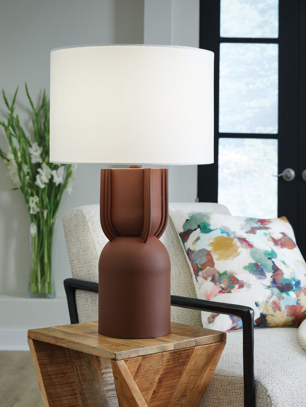 Modern and monochromatic, this table lamp illuminates your home in luxe style. It reflects your contemporary eye for design with a brick red finish and artisanal silhouette. What a refined addition to your living room or office.<br><br><b>Additional Dimen