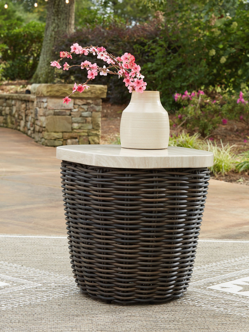 Add luxury, convenience and durability to alfresco fun. This outdoor end table captures the textural beauty of wicker while withstanding the elements, from rain to shine. With its marble-look aluminum top, you can stylishly keep your pool-side drinks or r