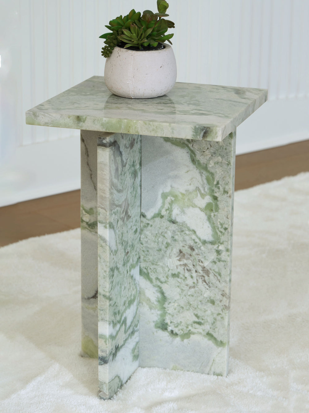 Elevate your space with exquisite natural beauty. With its sleek design and unique green veining, this marble accent table is a standout piece that effortlessly blends with contemporary decor. Perfect for placing next to your couch or bed, the functional 