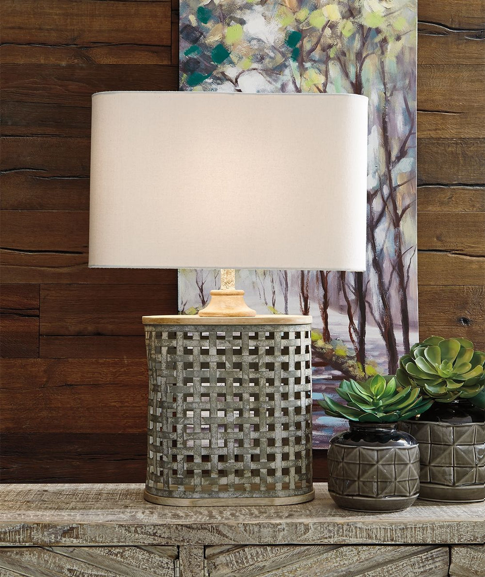 Whether your look is coolly contemporary or retro chic, this neutral table lamp simply delights. Its whitewashed finish over galvanized metal adds the perfect rustic refined tone. The shapely base, placed next to a sofa or beside a bed, rounds out the loo