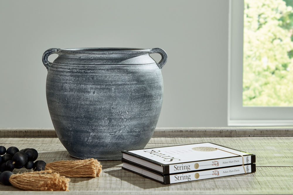Understated in its beauty, this vase offers a traditional feel courtesy of its terra cotta construction. The antiqued look is brought into the present with a distressed blue hue. It-'s an effortless way to elevate a centerpiece, bookshelf or mantle. Add f