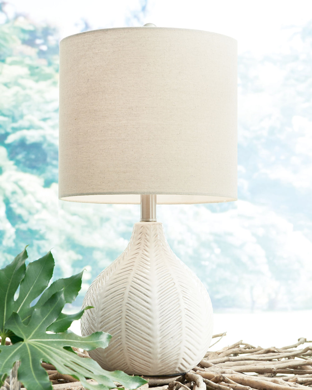 Reflect your effortlessly chic sensibility with this artful ceramic table lamp. Its textural surface is enriched with a herringbone pattern and a gorgeous glaze for a hint of sheen. Whether your look is clean and modern or cool and eclectic, this lamp is 