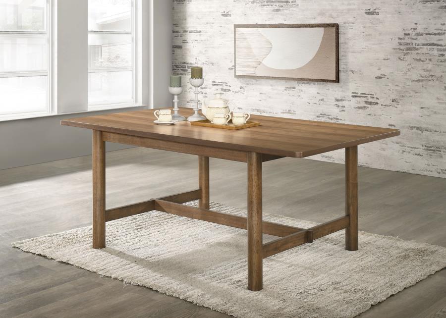 Enjoy the trestle base and inviting style of a modern rectangular dining table. Designed for casual appeal in your kitchen or dining room, it features a natural walnut finish over walnut veneer. The table is a warm and inviting centerpiece for your eat-in
