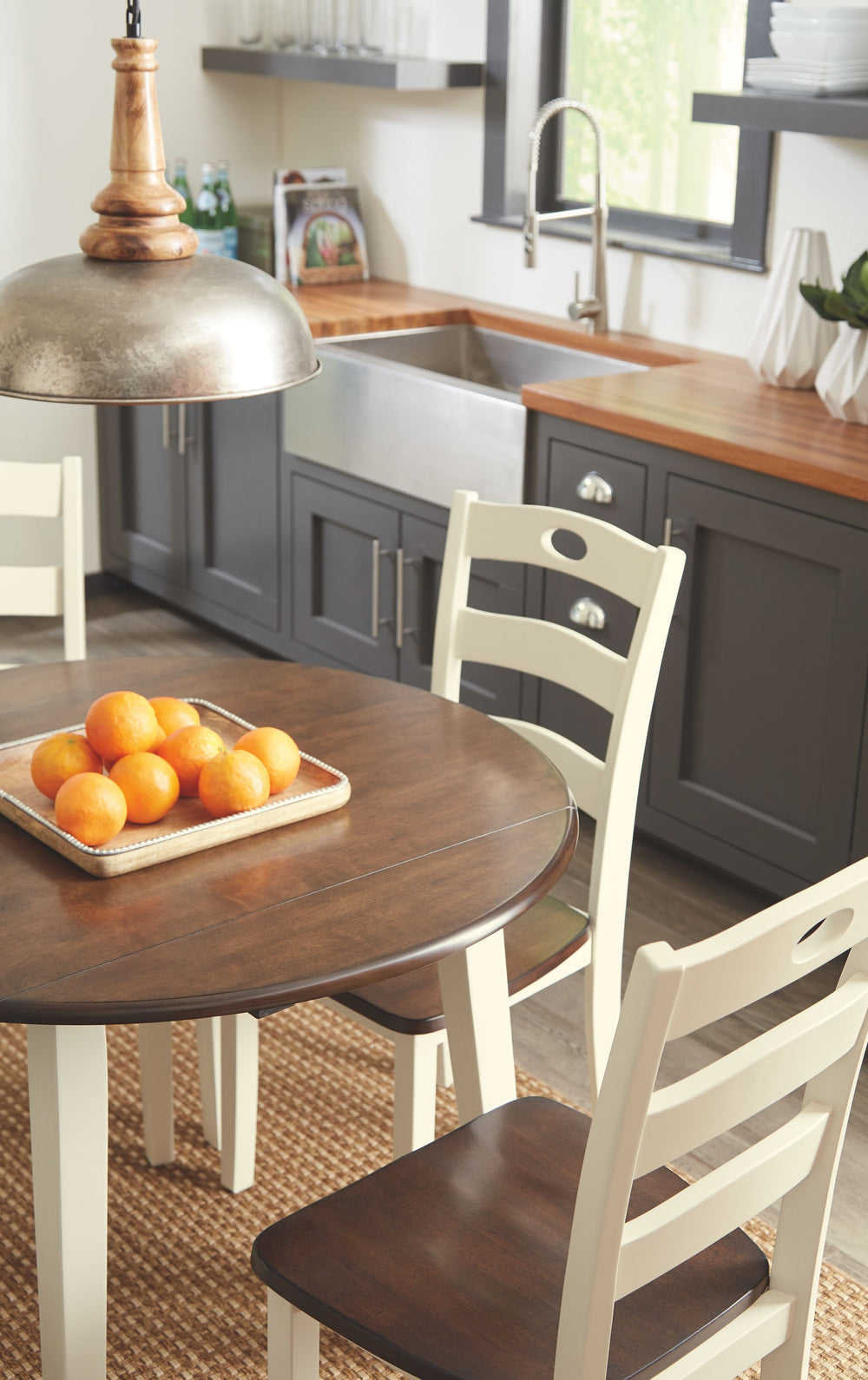 Turn your eat-in kitchen or dining space into a cottage-chic retreat with this round drop leaf table. Two-tone finish serves up a double helping of charm. When accompanied by the matching ladderback chairs, what a storybook scene.<br><br><b>Additional Dim