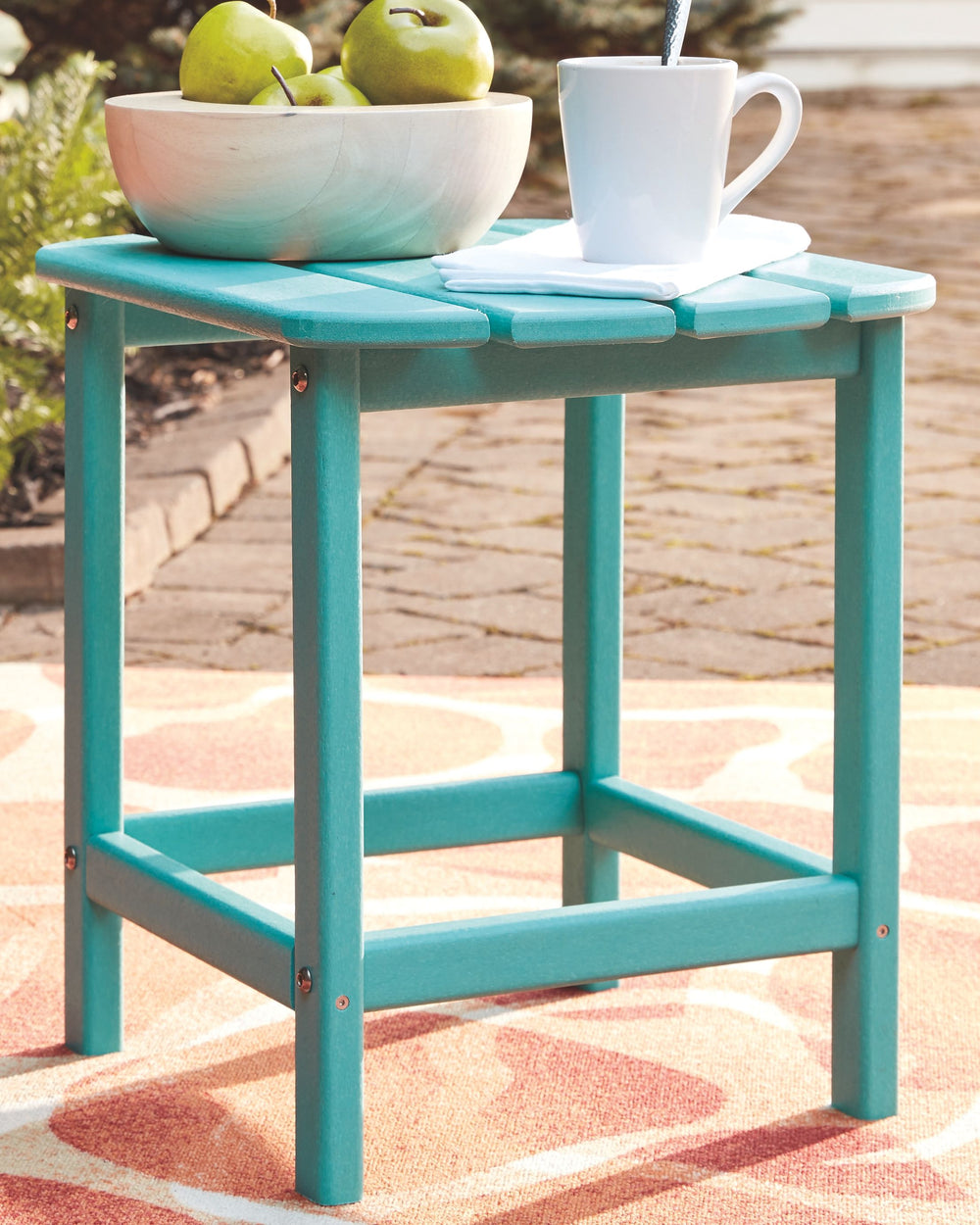 Add cottage-quaint charm to your outdoor oasis with this outdoor end table in turquoise. Made of MEGA-TUFFÂ® high-density polyethylene material, itâ€™s sure to weather the seasons beautifully. Designed to shed rainwater, the tableâ€™s slatted top with gen