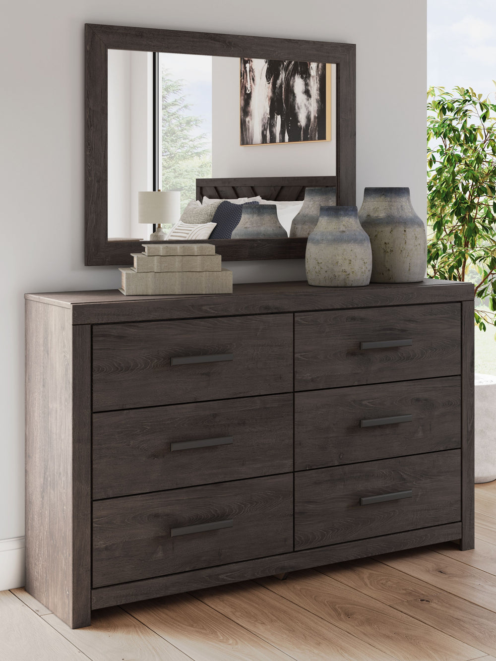 Designed with everyday style in mind, this dresser with mirror is a simply chic approach to modern living. A dark charcoal finish blends black and brown undertones, creating a versatile look that effortlessly pairs with your existing pieces. And for must-