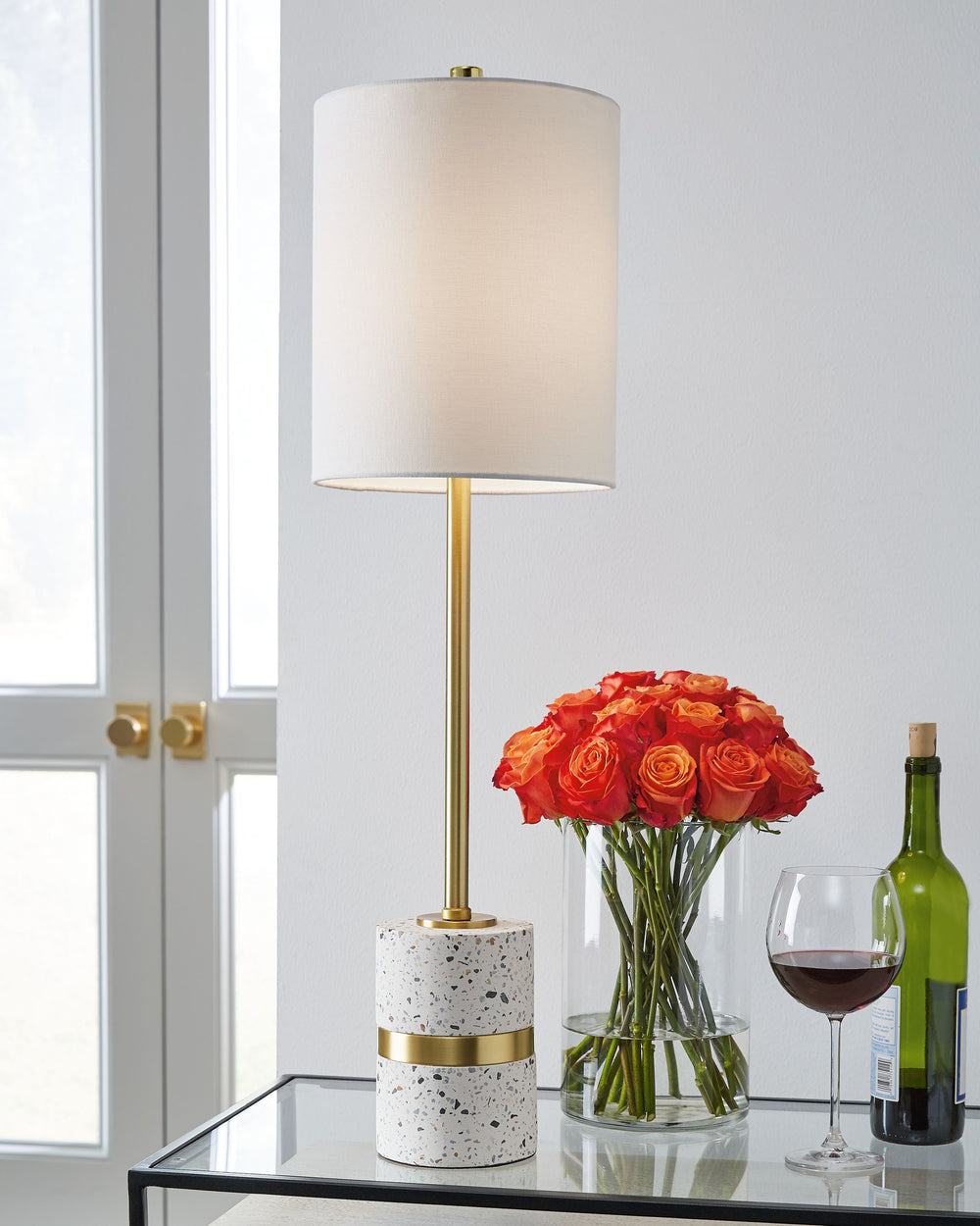 What better way to get on trend than with this terrazzo table lamp? It combines the cool hues of the traditional Venetian material with sleek contemporary styleâ€”and just a note of mid-century retro flourishes. In off-white, this piece will complement a 