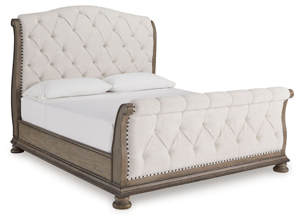 Merging traditional elegance with modern comfort, this king upholstered sleigh bed takes your bedroom retreat to the next level. It radiates timeless sophistication with its shapely curves, glazed antiqued-look finish and tufted cushions. Talk about stunn