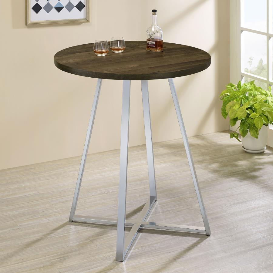 Host your closest friends around this contemporary bar table. Designed with a round, brown oak finished top, this sleek modern bar table invites you stand and converse around or pull up a coordinating rustic-inspired bar stool. Slim metal bars in a bright