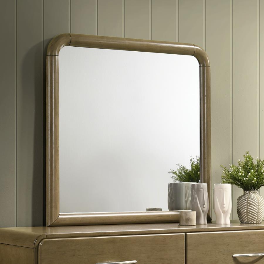 This dresser mirror brings light and elegance to your bedroom with its clean lines and rounded frame. The nutmeg wood finish offers a warm and inviting feel, perfect for complementing both modern and traditional decor. Its curved top and soft edges create