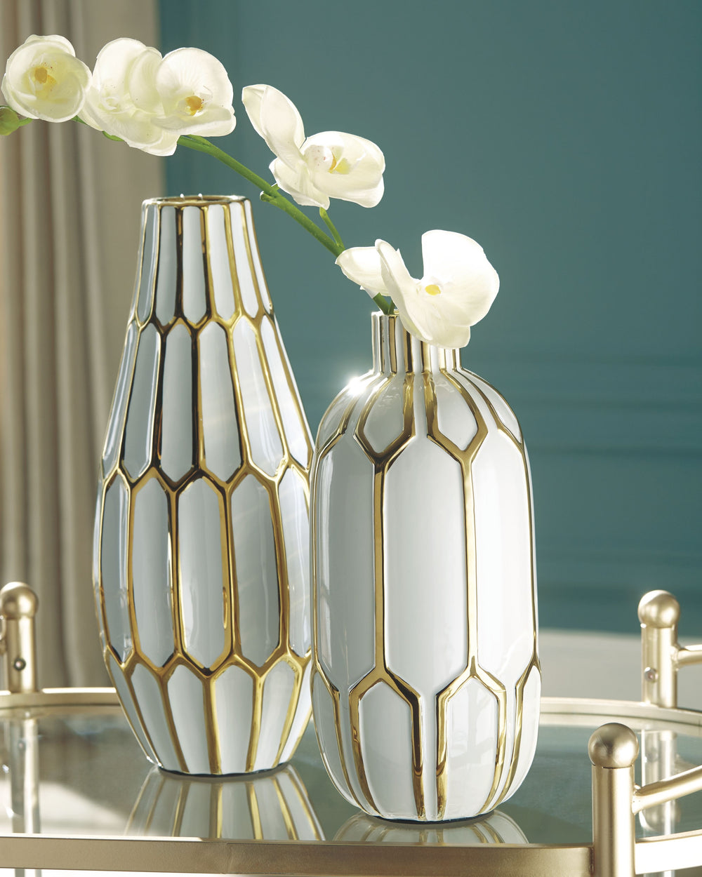 Stunning in goldtone and white, this 2-piece vase set is what your homeâ€™s been missing. Varying sizes in the honeycomb-inspired geometric pattern bring visual appeal. These vases arenâ€™t just good for looks, theyâ€™re durable enough to go outside, too.