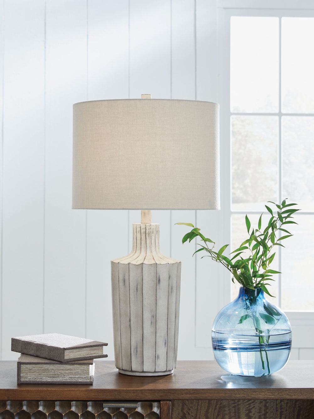 Exuding a casually cool sensibility, this table lamp is a bright idea whether itâ€™s in a living space, bedroom or entry. The shapely base sports a vertical line pattern with a distressed finish that enhances its relaxed appeal.<br><br><b>Additional Dimen