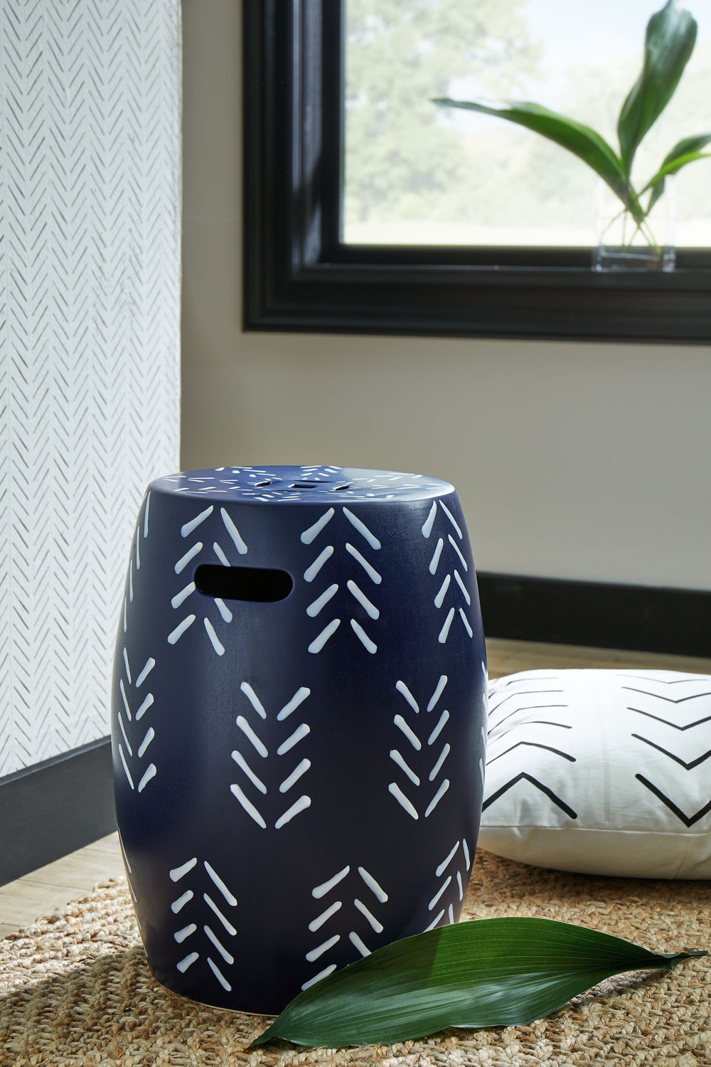 Freshen up your decor with the striking design of this stool. A navy and white pattern plays up the pieceâ€™s visual appeal, while hand holds on the sides and a drain opening on top provide modern functionality. Suiting both indoor and outdoor spaces, thi