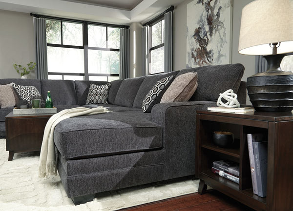  the sectionalâ€™s slate gray upholstery is