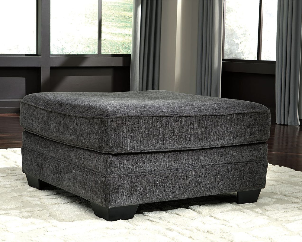 The ultimate sectional centerpiece, this oversized ottoman is big on cool, contemporary style and long on comfort. Plushly upholstered in a slate gray fabric, this ottoman is so generously scaled, you can top it with a serving tray and still have plenty o