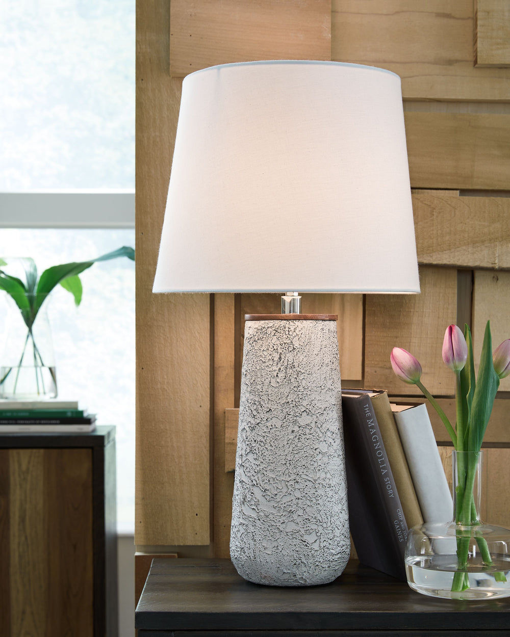 Modern industrial design in a new light. A mixed-media masterpiece, this table lamp provides maximum interest and exceptional versatility with its heavily textured surface. Whether resting on your nightstand or set on a side table, it delivers a unique ae