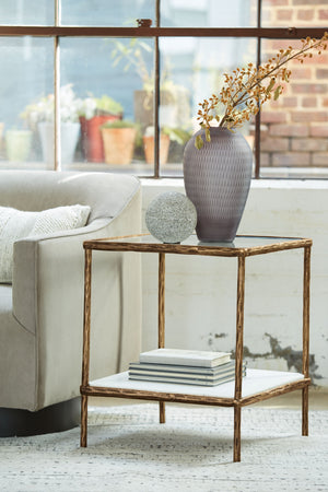  this accent table provides both flair and function. The glass tabletop offers the perfect perch for a lamp