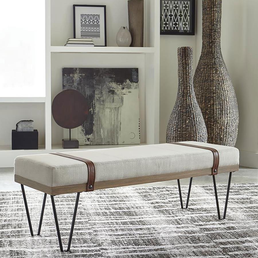 Dress up a living room with the interesting details from this modern rustic bench. Featuring open hairpin legs in a black finish, this bench marries a variety of design elements to make a statement. Classic colors, such as beige, add texture to the straig