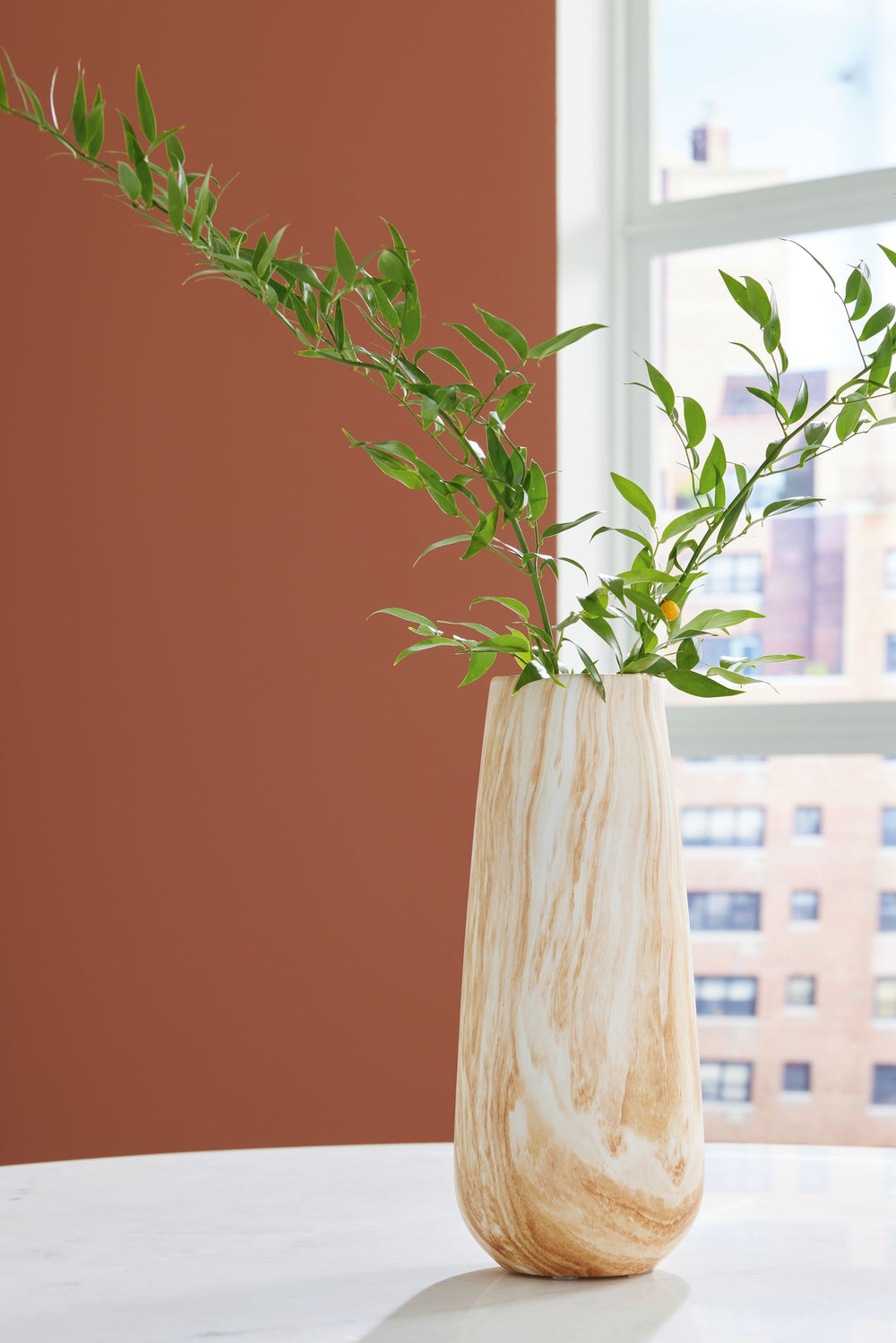 Naturally flowing swirls and neutral hues give this sleek ceramic vase a wonderfully organic feel. It accommodates faux florals and other decorative fillers with ease. Whether itâ€™s on an entryway table, desk or bookshelf, this striking vase is a tastefu
