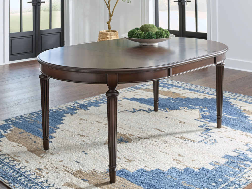 Serve up elegance and poise with the Lavinton dining package. Its traditional silhouettes are detailed with reeded accents for added opulence. From breakfast to dinner, this set elevates your dining experience with classic beauty. <h4><b>Lavinton - Brown 
