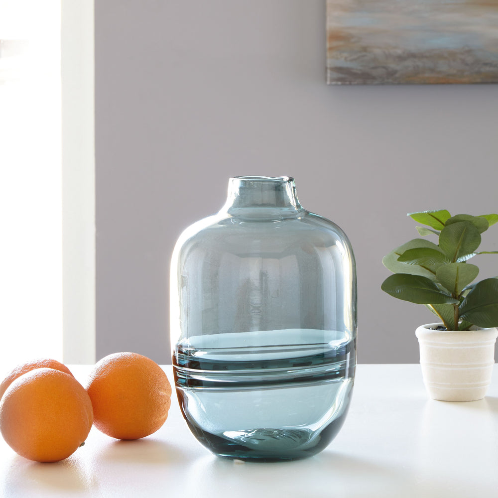 Polish off your patio dining table or office bookshelf with the unassuming-yet-impactful styling of this vase. Its teal finish provides an opaque pop of color to your contemporary decor. Subtle in design, use this vase to punctuate the end of a mantel. Or