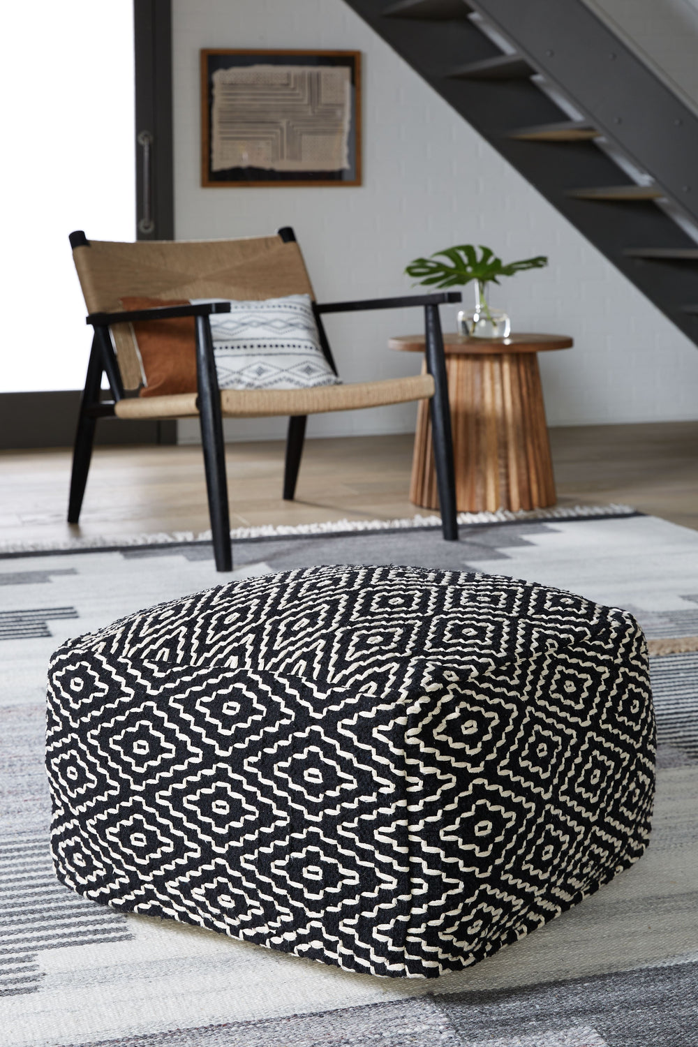 A handwoven geometric design in a color scheme that fits every decor. Those are just a few of the things to love about this casually cool pouf. Whether itâ€™s used as a comfy footrest or staged beside a coffee table or chairside, this easy-to-stow piece i