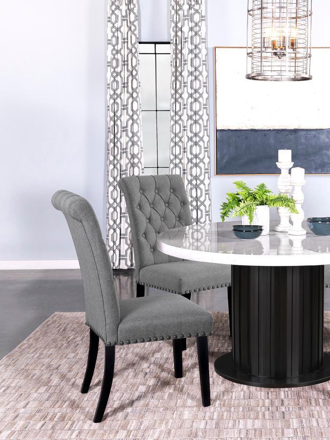 Blending timeless elegance with plush comfort, this side chair enhances any dining space. Its high backrest features a classic button-tufted design, adding depth and sophistication. A rolled top and hand-applied nailhead trim create refined detailing, whi