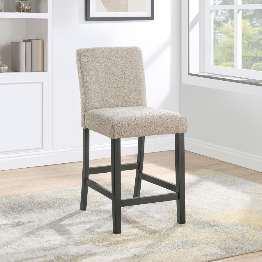 Elevate your dining experience with this chic counter height chair, a blend of simplicity and texture. Wrapped in the luxurious touch of boucle fabric, the chair offers a tactile feast, inviting guests to savor every second seated. Its silhouette stands t