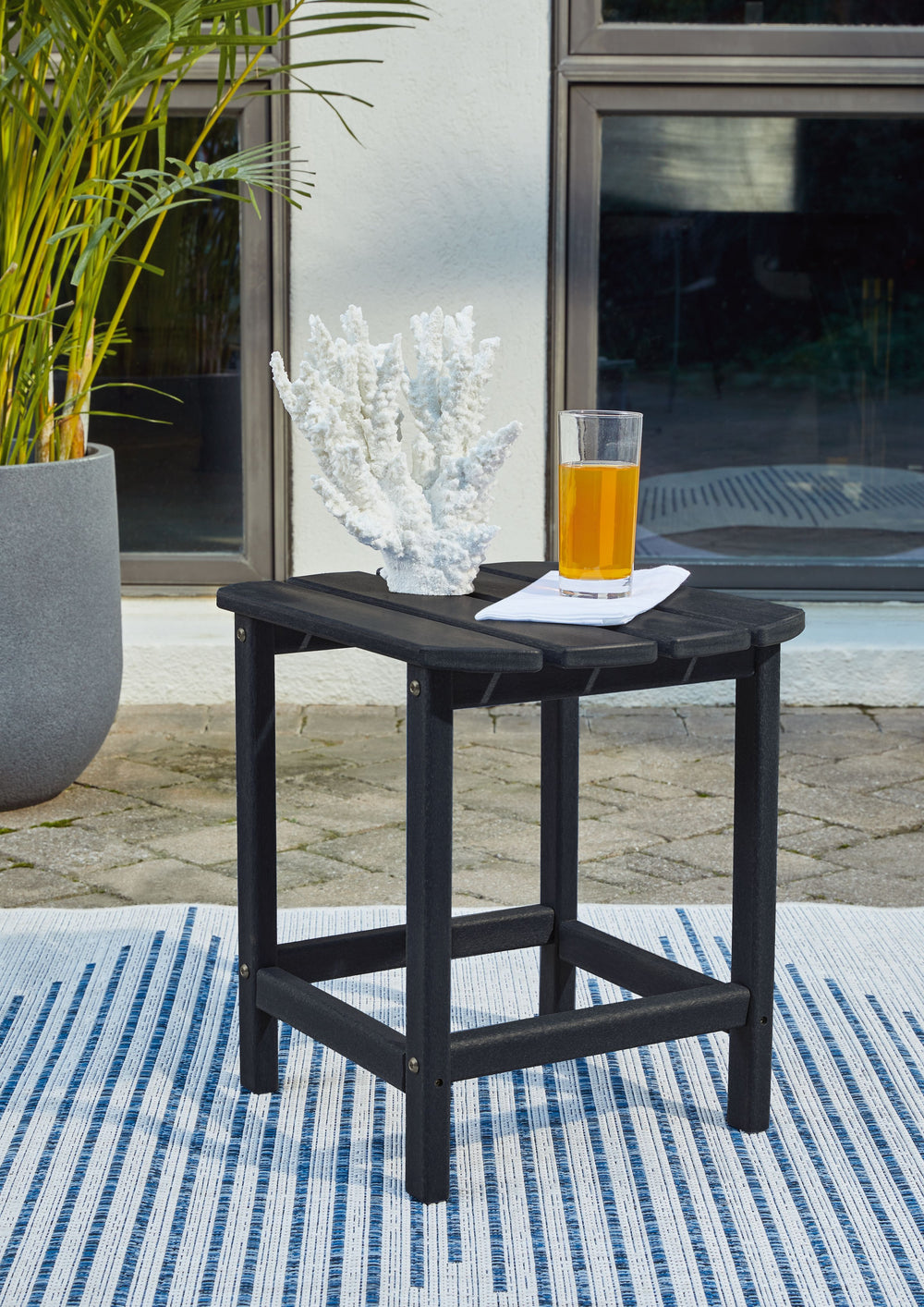 Add cottage-quaint charm to your outdoor oasis with end table in black. Made of MEGA TUFFâ„¢ high-density polyethylene material, itâ€™s sure to weather the seasons beautifully. The ottoman-'s slatted styling with sloped shaping provides exceptional form a