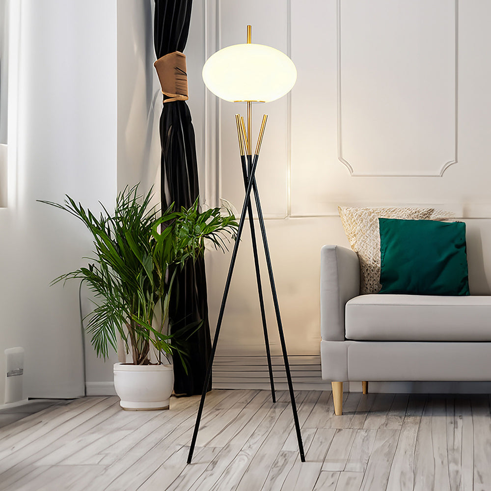 Enhance your living space with a floor lamp that exudes contemporary sophistication and artistic flair. Its elegant tripod base, crafted with sleek black and gold accents, creates a striking visual statement while providing a sturdy foundation. The center